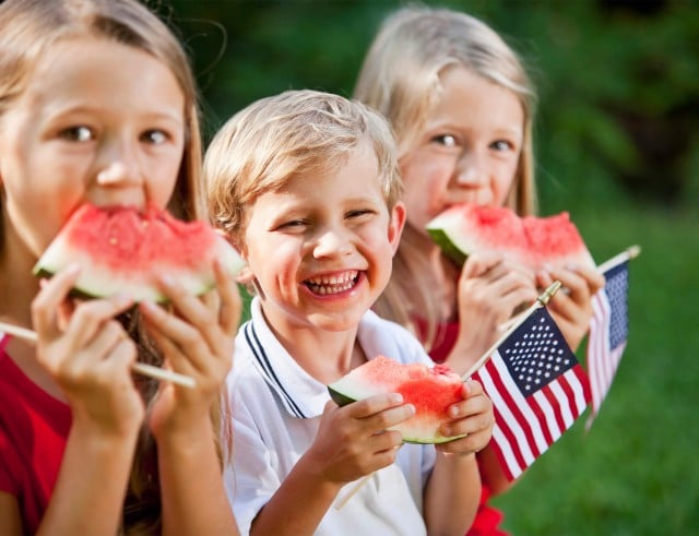 Kids with watermelon at Fourth July in Madden's - Minnesota weekend getaways