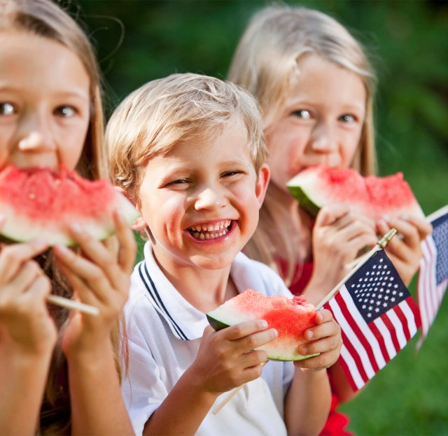 Kids with watermelon at Fourth July in Madden's - Minnesota weekend getaways