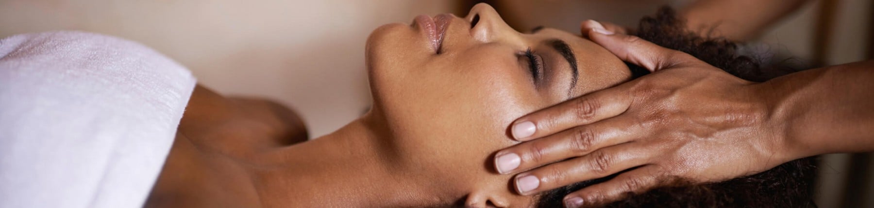 A woman receiving a forehead massage