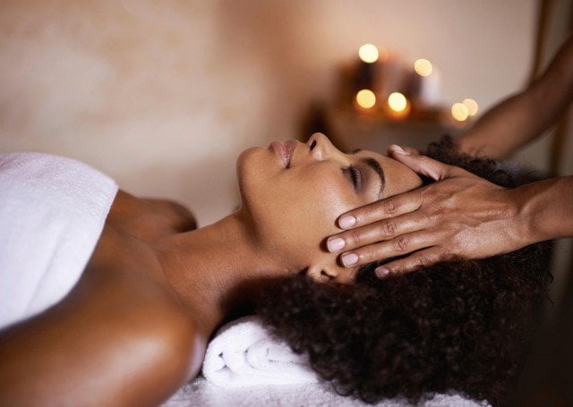 A woman receiving a forehead massage
