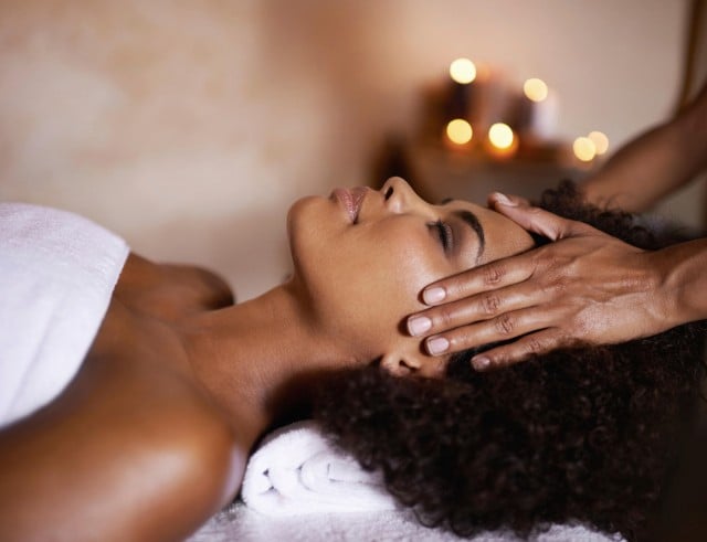 A woman receiving a forehead massage
