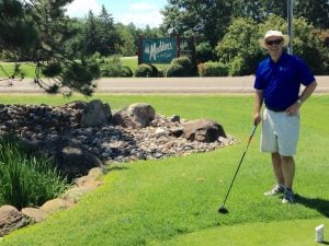 Tom Hoyt with a golf club at Madden's golf course