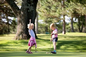 Little girls playing golf