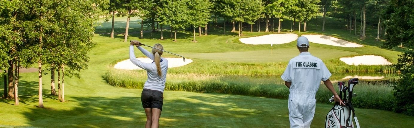 Woman taking golf swing at the Classic golf course at Madden's on Gull Lake