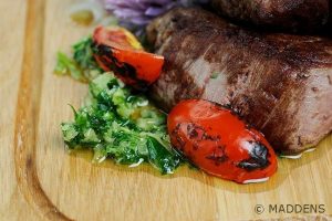 Steak served with tomatoes