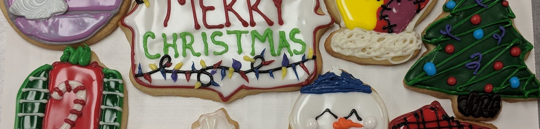 Festive Sugar Cookies beautifully decorated with icing reading Merry Christmas