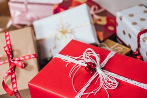 Beautifully wrapped white and red gift boxes with delicate string bows and adornments