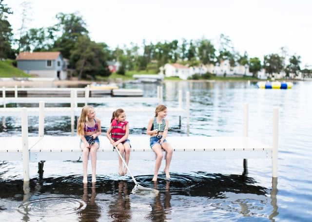 Three little girls fish off the dock of Madden's marina on Gull Lake