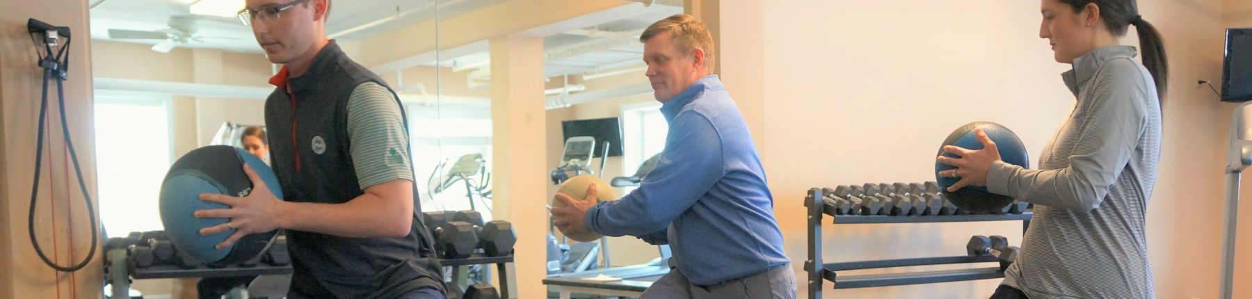 People working out in the fitness centre with balls