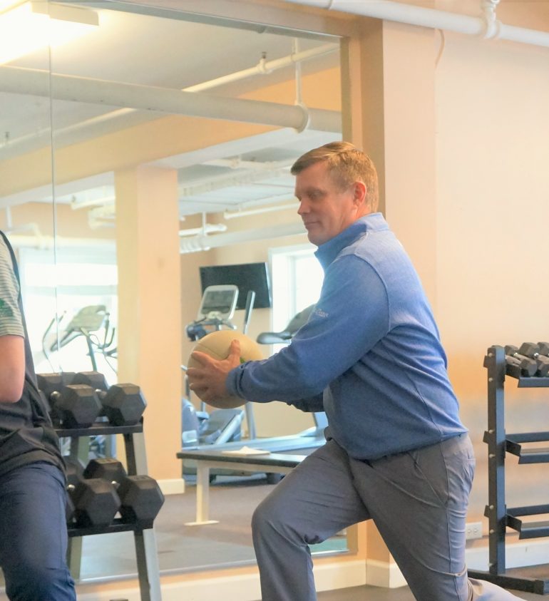 People working out in the fitness centre with balls