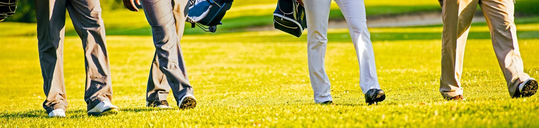 Half body shot of golfers walking on a golf course at Madden's on Gull Lake