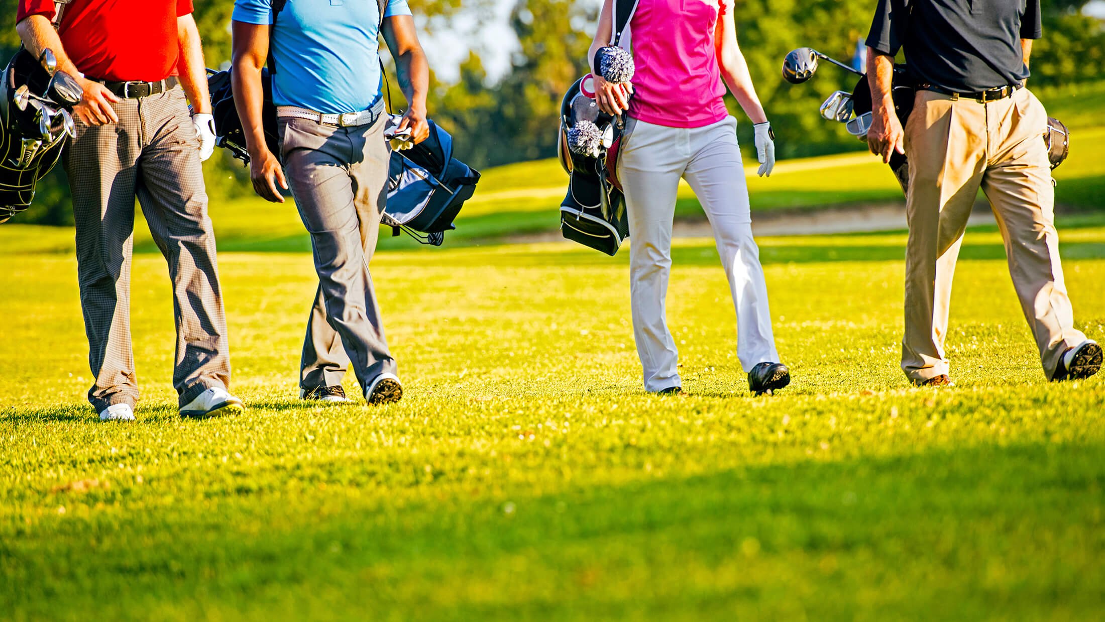 Half body shot of golfers walking on a golf course at Madden's on Gull Lake