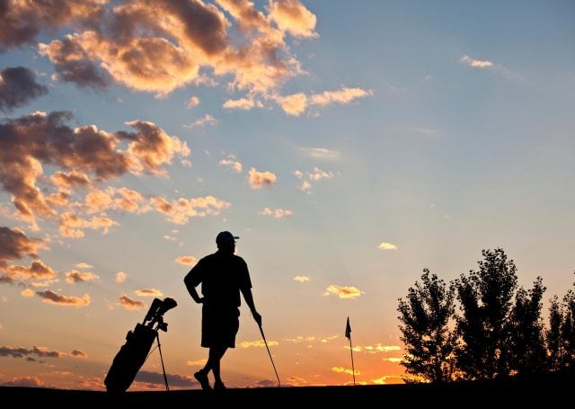 Rearview of a golfer during sunset at Madden's on Gull Lake