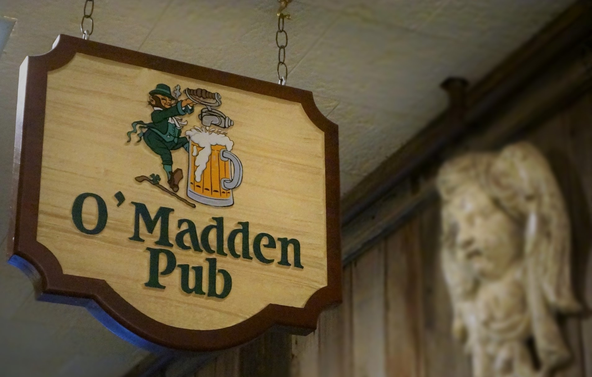 Closeup of the O'madden's pub wooden signage at the entrance of the pub