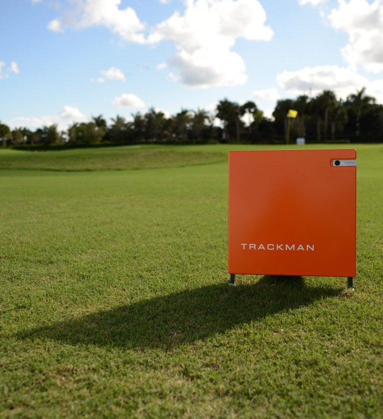 A Trackman golf tracker device placed on the grass.