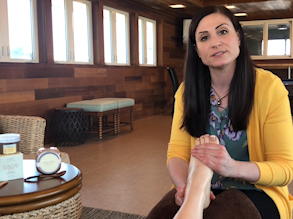 A beautician massaging a woman's foot