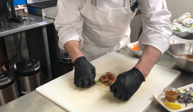 A chef making spring rolls