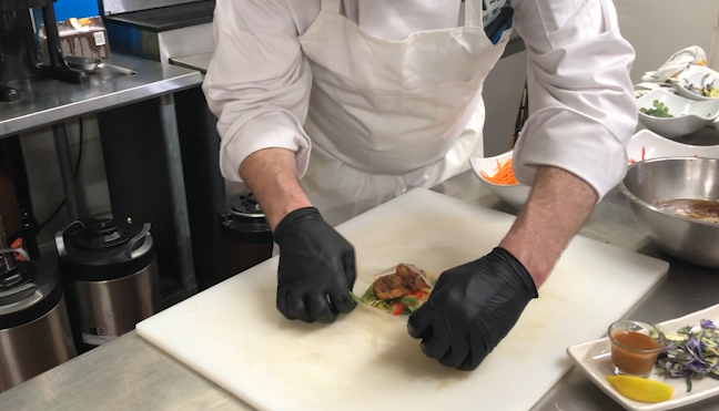 A chef making spring rolls