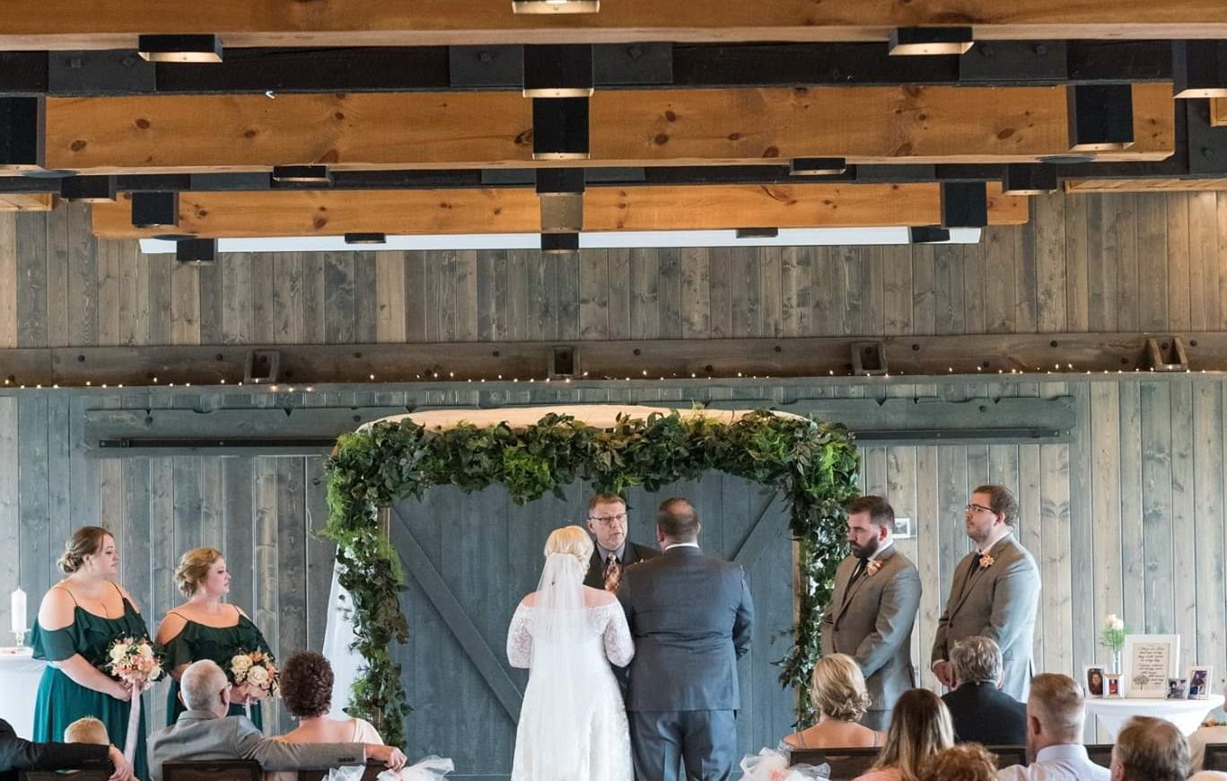 Rearview of a brides and groom at the aisle as seated guests look on