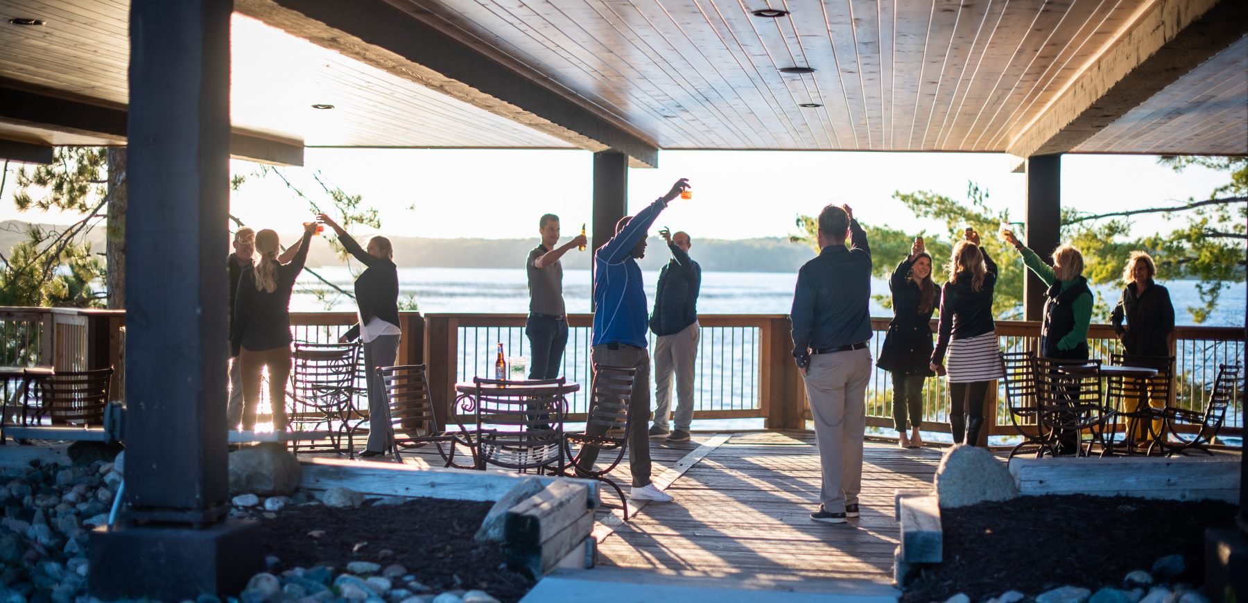 Group of people raising their glasses to toast in the Pavilion patio area