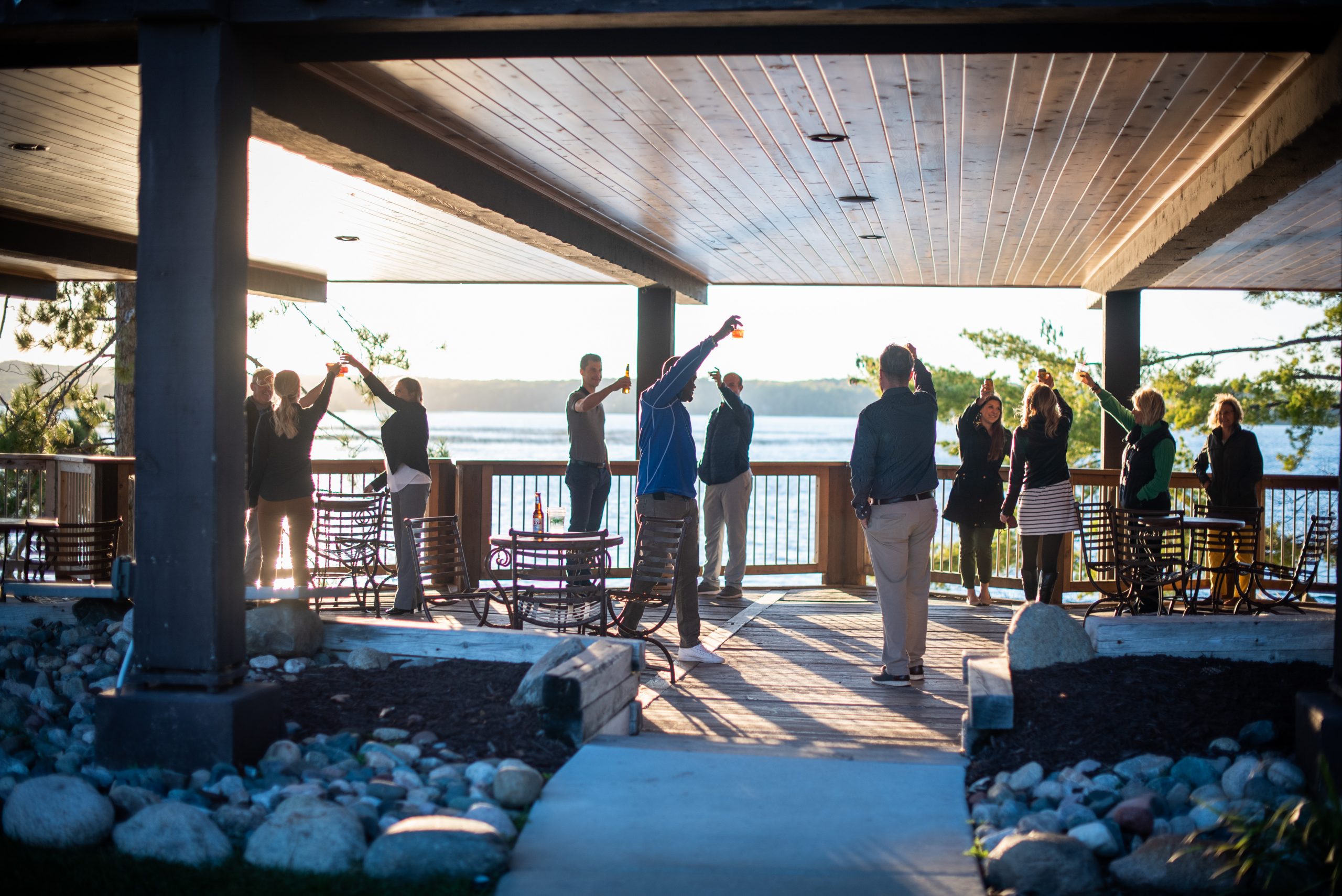 Group of people raising their glasses to toast in the Pavilion patio area