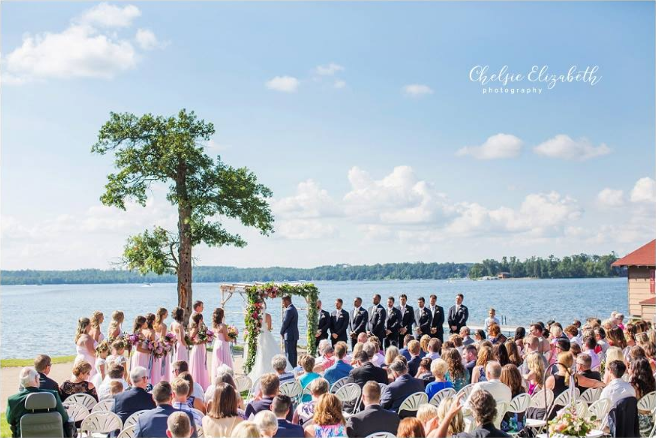 Bride and groom exchanging vows as wedding guests look on