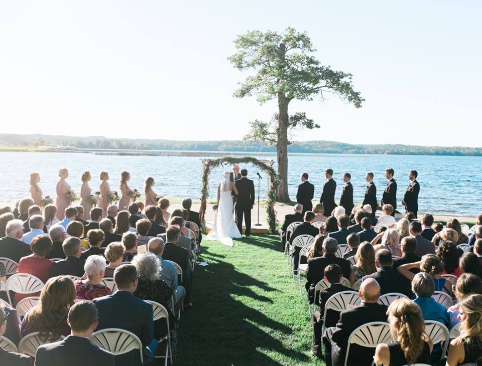 High angle shot of seated guests looking on to the bride and groom