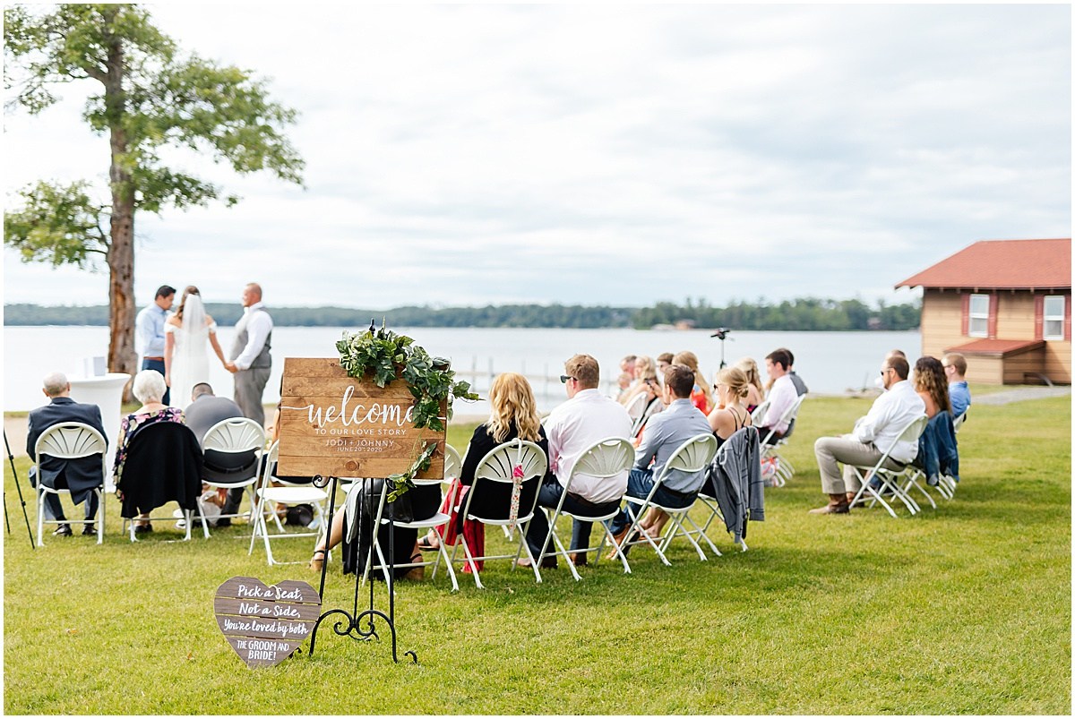 Back shot of the seated wedding guests looking on to the bride and groom