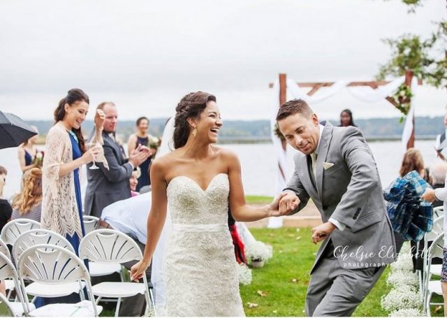 Bride and groom walking down the aisle as the guests look on