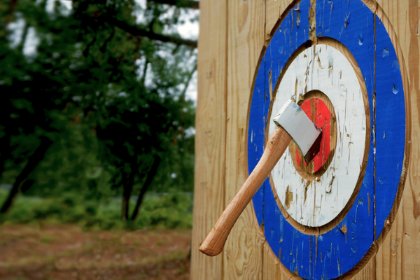 axe stuck in bullseye of wooden target