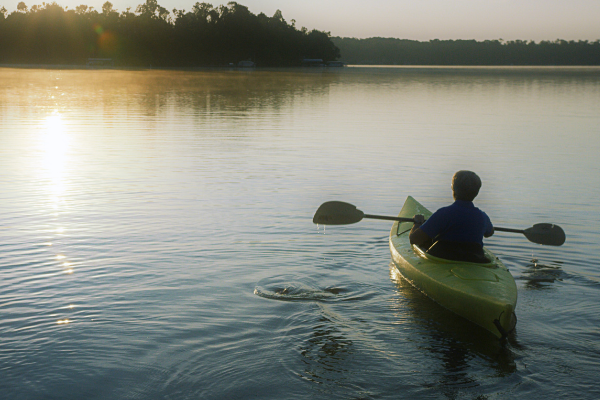 person kayaks on lake