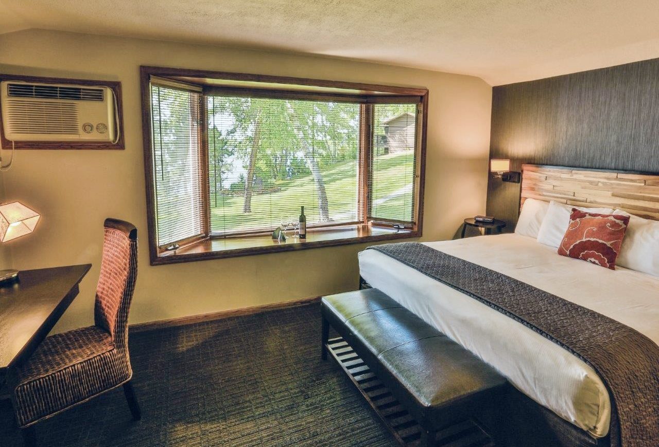 king size bed in hotel room with bay window