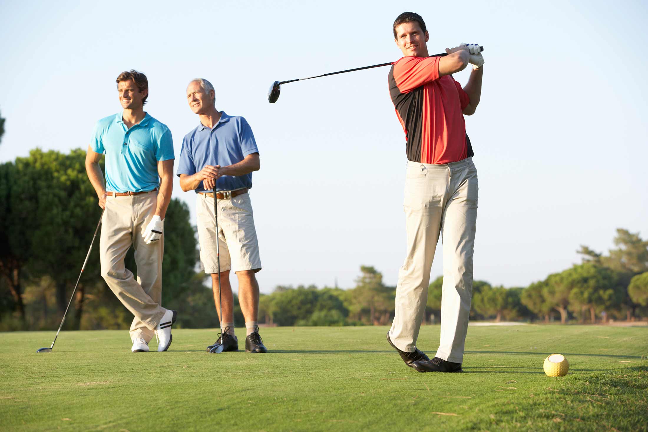 3 men playing golf