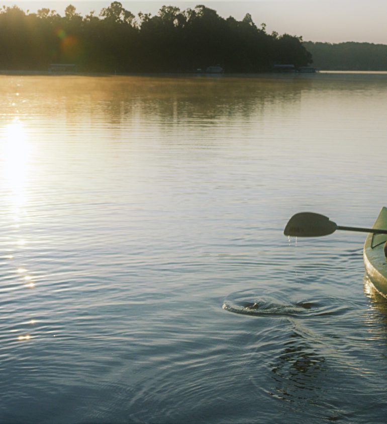 person kayaks on lake