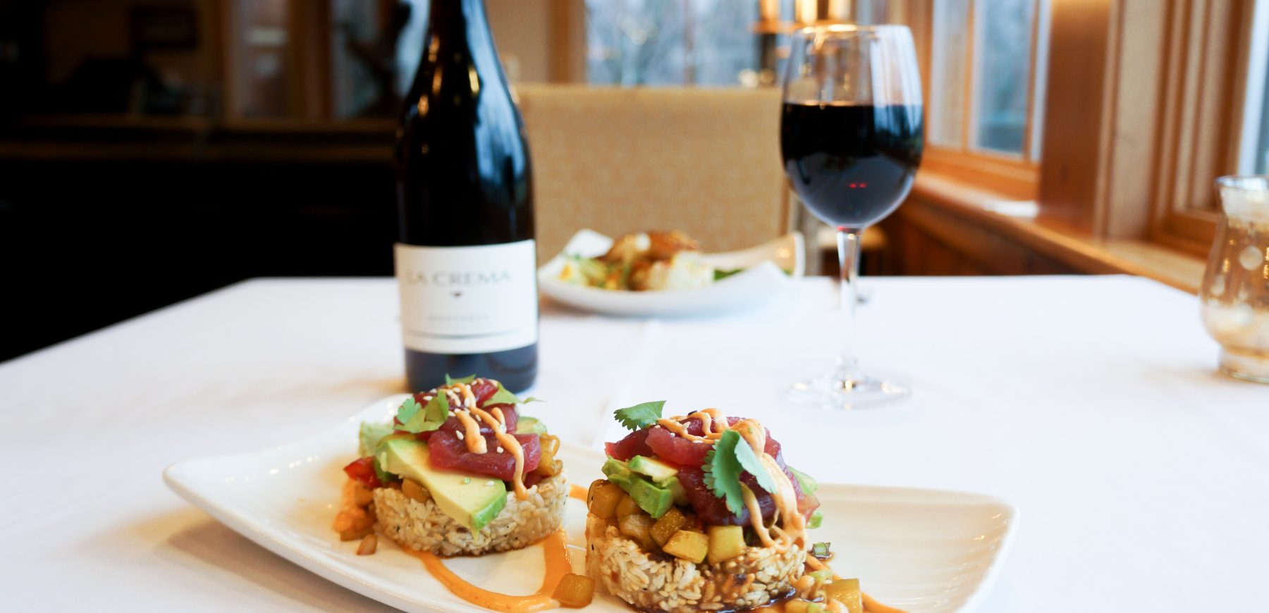 grilled sushi stacks with glass and bottle of red wine