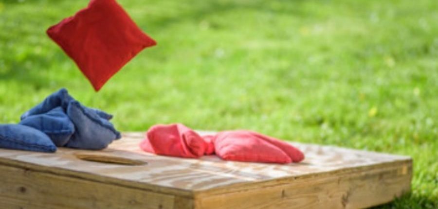 bean bag being thrown in game of corn hole