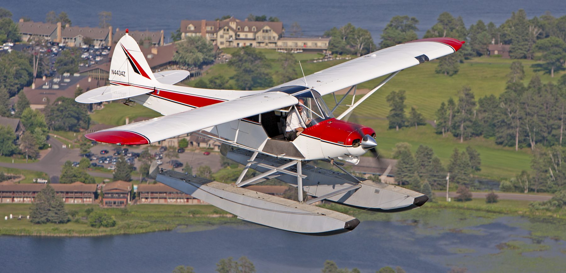 Super Cub Seaplane in Flight over Madden's on Gull Lake