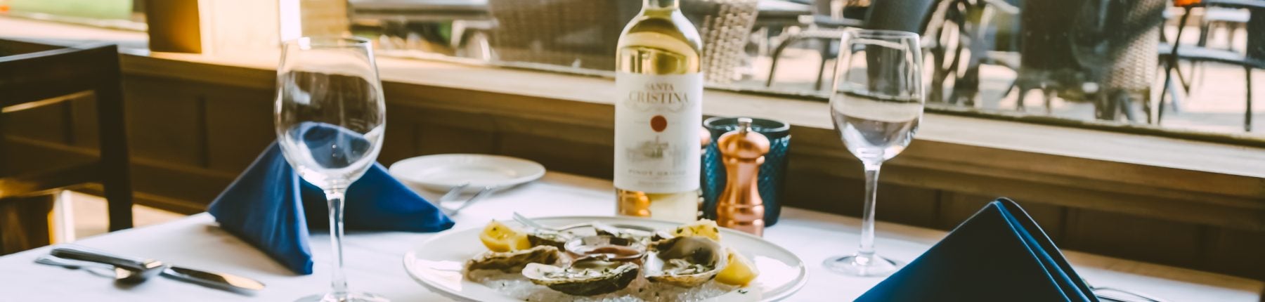 plate of oysters and a bottle of white wine