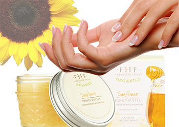 Farmhouse Fresh's Honey Butter cream next to a freshly manicured hands
