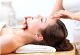 A woman receiving facial massage