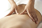 A therapist massaging a client's lower back